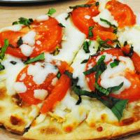 Margherita · Roma tomatoes, garlic, fresh basil, and mozzarella.