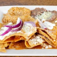 Chilaquiles · Fried tortillas topped with spicy red or green sauce. Cotija cheese, queso fresco, sour crea...
