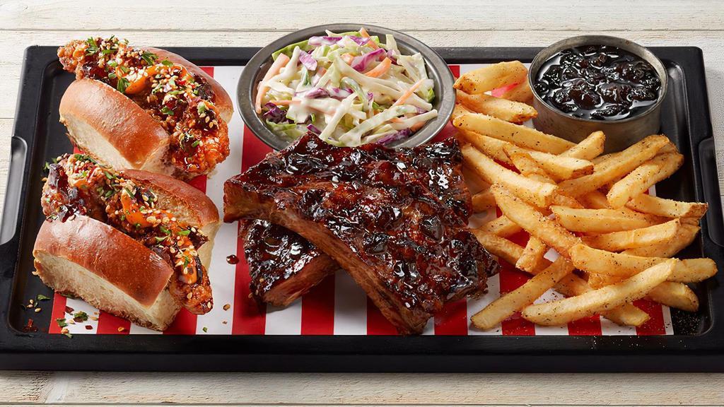 Fridays™ Whiskey-Glazed Chicken Slammer Board · Chicken fingers tossed in Whiskey-Glaze on mini New England rolls with spicy aioli and sesame seasoning. Paired with two 2-bone cut Whiskey-Glazed Big Ribs, coleslaw and seasoned fries.