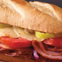 12' Italiano Sub · Ham, salami, provolone cheese, banana peppers, tomatoes, red onions, and sub dressing.  12