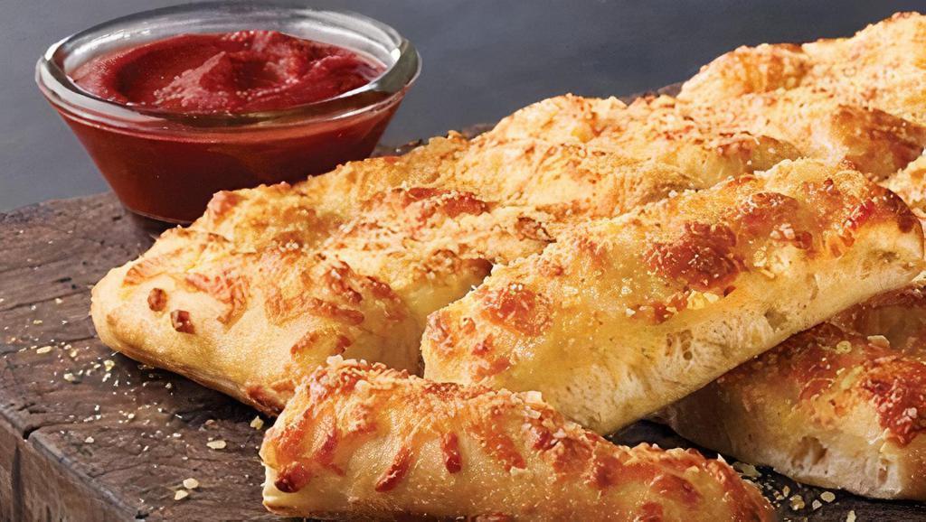 Cheezy Bread · Fresh-baked bread strips with our signature three cheeses and garlic sauce, served with a side of our original pizza sauce and ranch dipping sauce. 90 cal. per piece.
