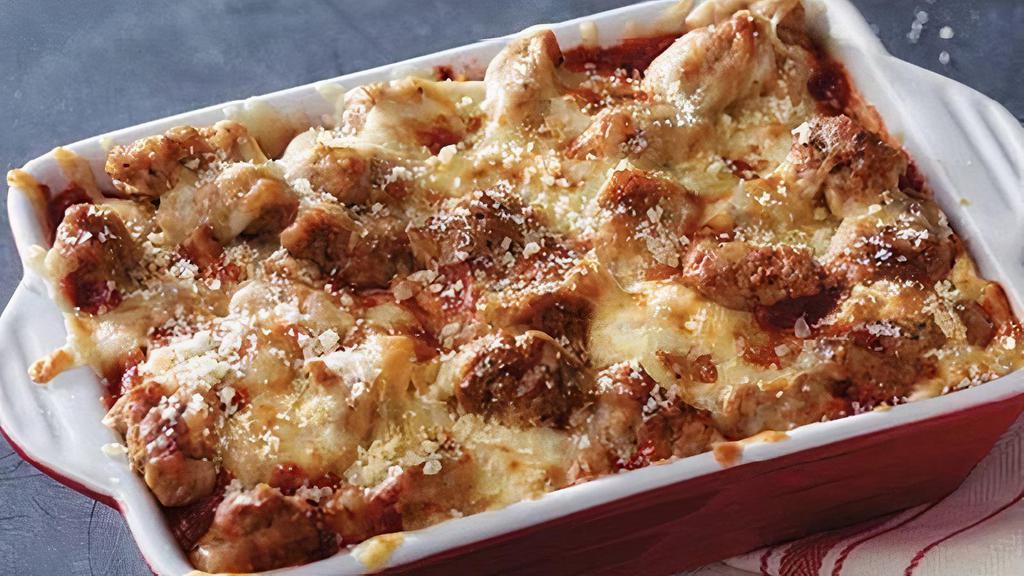 Meatball Bake · Marco's meatballs and sausage baked with our original sauce and signature three cheeses, topped with parmesan cheese.