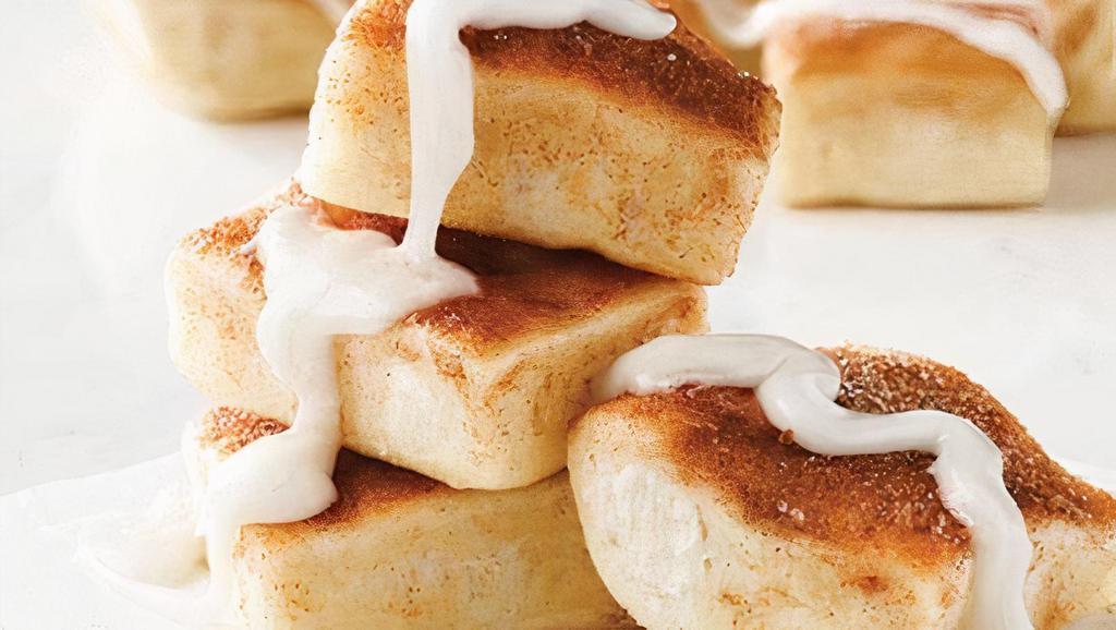 Cinnasquares · Fresh-baked, buttery pastry topped with cinnamon and sugar, served with a side of vanilla icing. 80 cal. per piece.