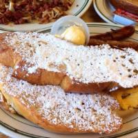 French Toast Combo · Carol's delicious french toast, bacon or sausage, two eggs.