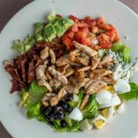 Cobb Salad · Grilled chicken, bacon, tomato, egg, bleu cheese crumbles, olives and avocado on a bed of mi...