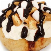 Campfire S'Mores Roll · marshmallow frosting topped with marshmallows, graham cookies and chocolate sauce
