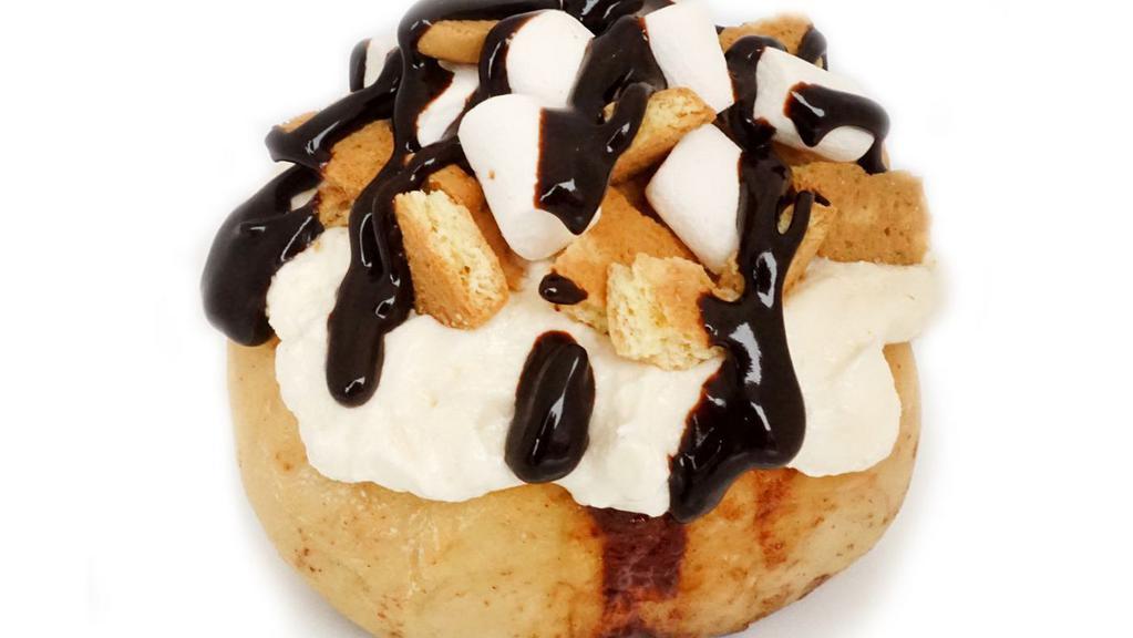 Campfire S'Mores Roll · marshmallow frosting topped with marshmallows, graham cookies and chocolate sauce