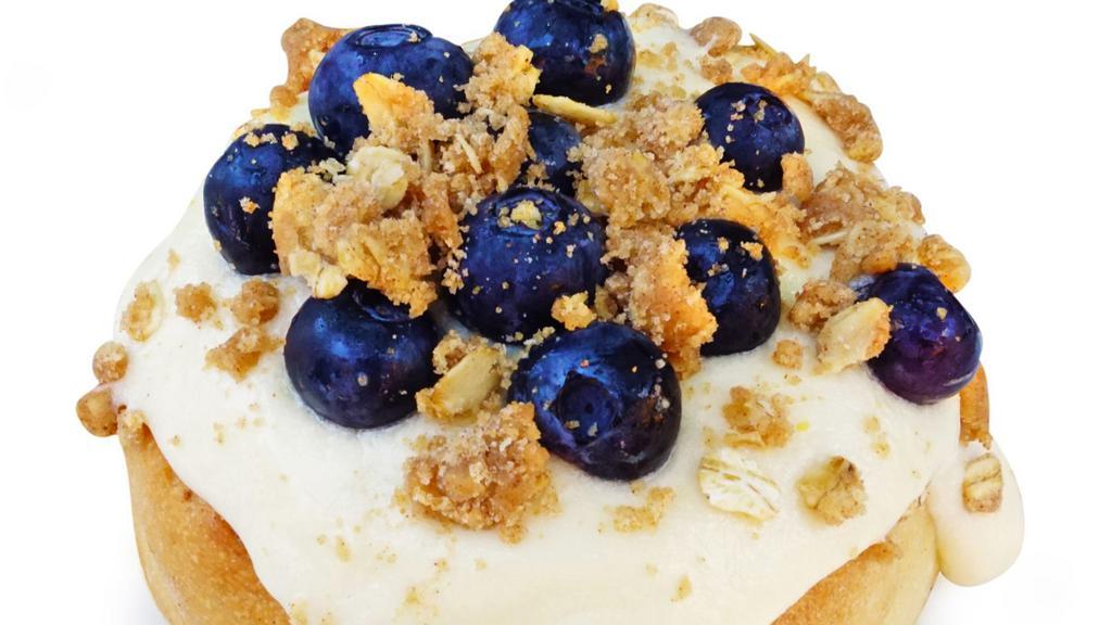 Blueberry Pie Roll · cream cheese frosting topped with blueberries and pie crumble