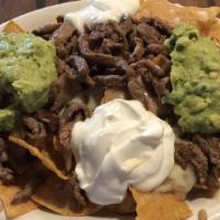 Nachos · Choice of chicken or steak topped with sour cream and cheese.