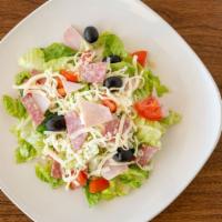 Antipasto Salad · Fresh mixture of iceberg and romaine lettuce, salami and ham topped with diced tomato, black...