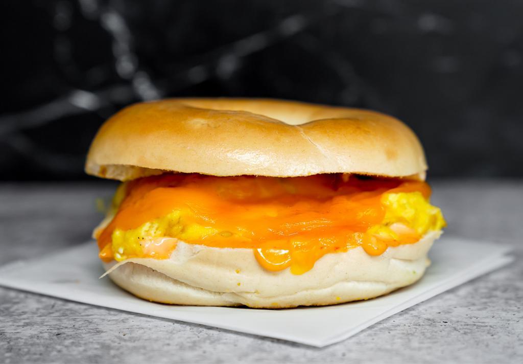 Bagel, Egg, & Cheddar Sandwich · 2 scrambled eggs, melted Cheddar cheese, and Sriracha aioli on a toasted bagel.