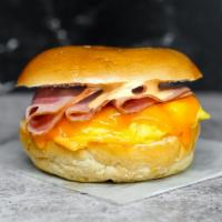 Bagel, Ham, Egg, & Cheddar Sandwich · 2 scrambled eggs, melted Cheddar cheese, sliced ham, and Sriracha aioli on a toasted bagel.