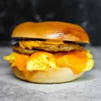 Bagel, Sausage, Egg, & Cheddar Sandwich · 2 scrambled eggs, melted Cheddar cheese, breakfast sausage, and Sriracha aioli on a toasted ...