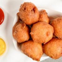 Hand-Dipped Corn Dog-Bites · Dipped in our homemade fritter batter. 8 per order, served with ketchup.