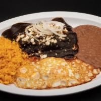 Enchiladas De Mole Negro · Served with beans and rice.