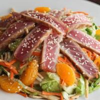Ahi Salad · Our marinated sashimi grade tuna thinly sliced over a mound of shredded cabbage and crisp ch...