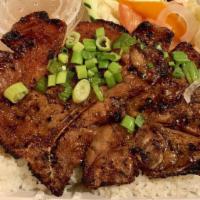 Grilled Pork Chop Broken Rice Plate / Cơm Tấm · Grilled pork chop served with assorted pickled vegetables, fresh vegetables, bowl of beef br...