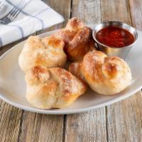 Garlic Knots · Four Dough knots brushed with garlic butter and topped with a generous sprinkle of parmesan ...