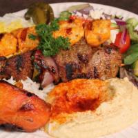 Combo Kebob Plate · One (1) beef kebob and one (1) chicken kebob served with 3 sides of your choice, grilled tom...
