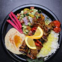Lamb Kebob Plate · Two (2) halal boneless lamb leg meat kebabs served with 3 sides of your choice, grilled toma...