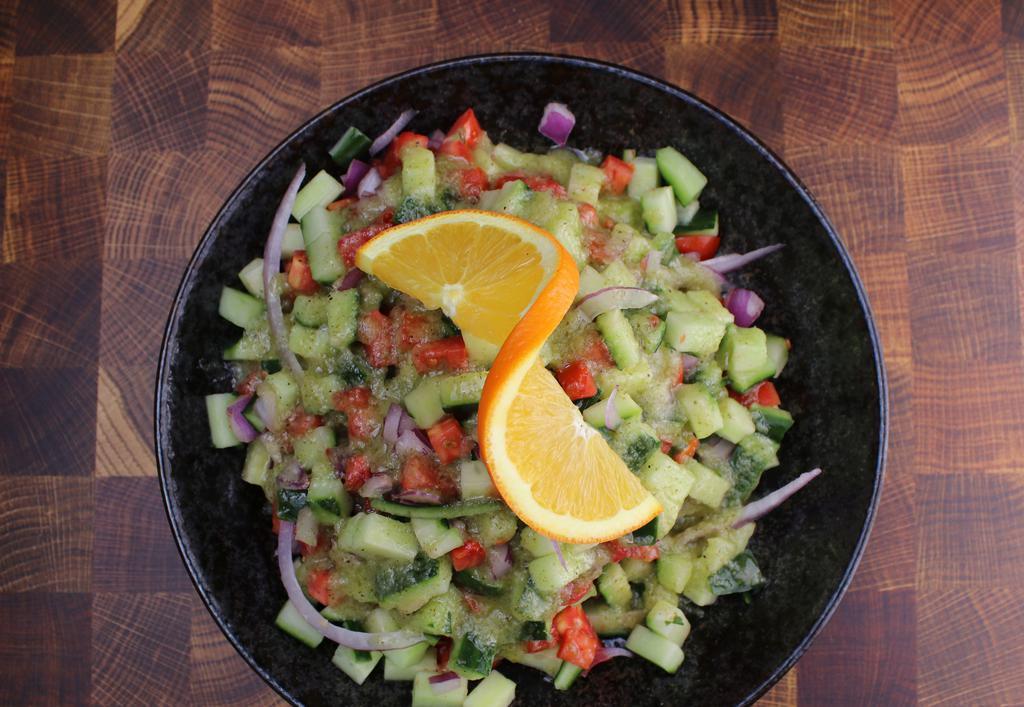 Shirazi Salad · Chopped tomatoes, cucumber, red onion, lemon mint dressing.