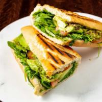 Vegan Sandwich · Zaatar, arugula, cucumber, tomato, avocado, and olive oil on a panini baguette.