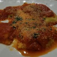 Ravioli Caprese · Signature dish, homemade ravioli, ricotta, marjoram, parmesan, fresh tomato sauce.