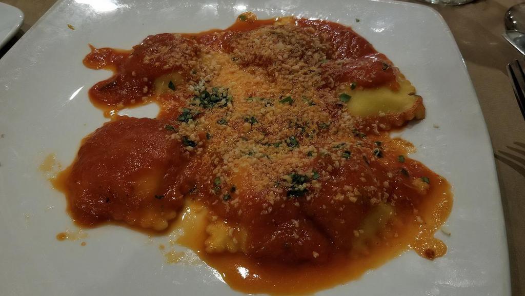 Ravioli Caprese · Signature dish, homemade ravioli, ricotta, marjoram, parmesan, fresh tomato sauce.