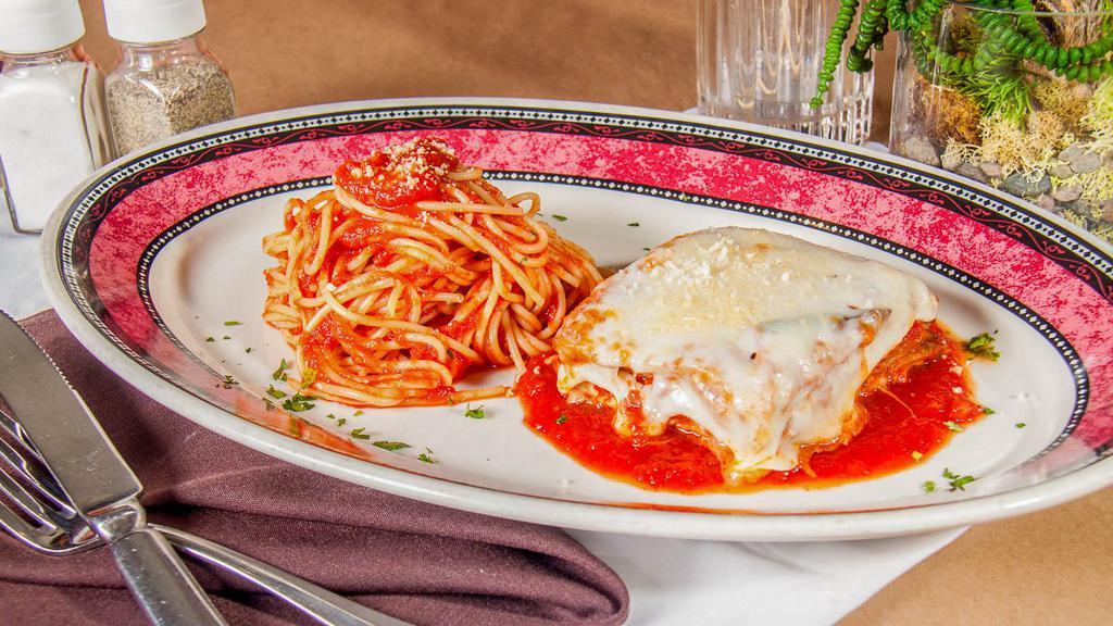 Pollo Parmigiana · Baked lightly breaded natural chicken breast, mozzarella, spaghetti in marinara sauce.