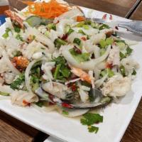 Seafood Salad · Assorted seafood mixed with green onions, red onions, lime juice and red chili.