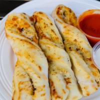 Garlic Parmesan Twists (6) · Fresh pizza dough folded twisted and baked with a Round Table Blend of cheese and seasonings