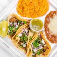 Taco Plate · 3 Tacos, your choice of meat, 
served with Spanish rice, Refried beans, 
cilantro, onions an...