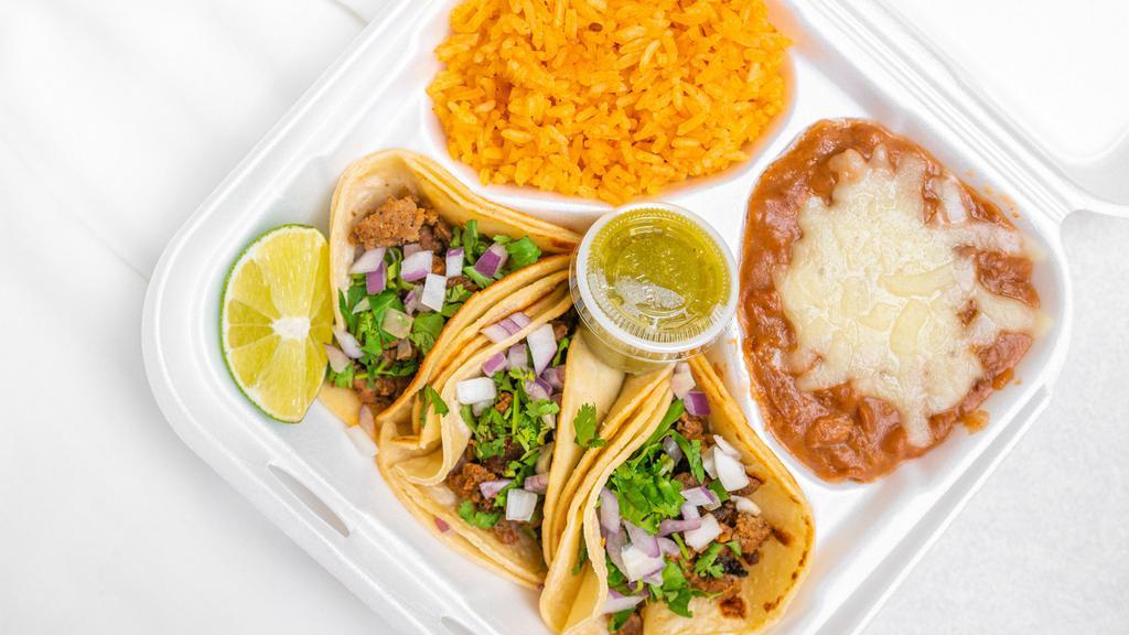 Taco Plate · 3 Tacos, your choice of meat, 
served with Spanish rice, Refried beans, 
cilantro, onions and salsa