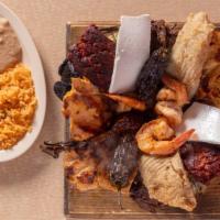 Molcajete Mixto · Includes asada (beef), pollo (chicken), chorizo (Mexican sausage), camaron (shrimp), filete ...