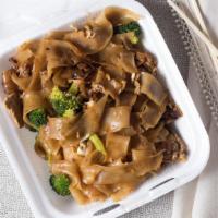 Pad See Iw · The plate of rice noodles with Chinese brown sauce and your choice of chicken, beef, or pork.