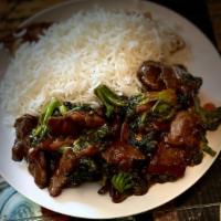 Beef & Broccoli · Served with rice and slices of cooked beef steak.