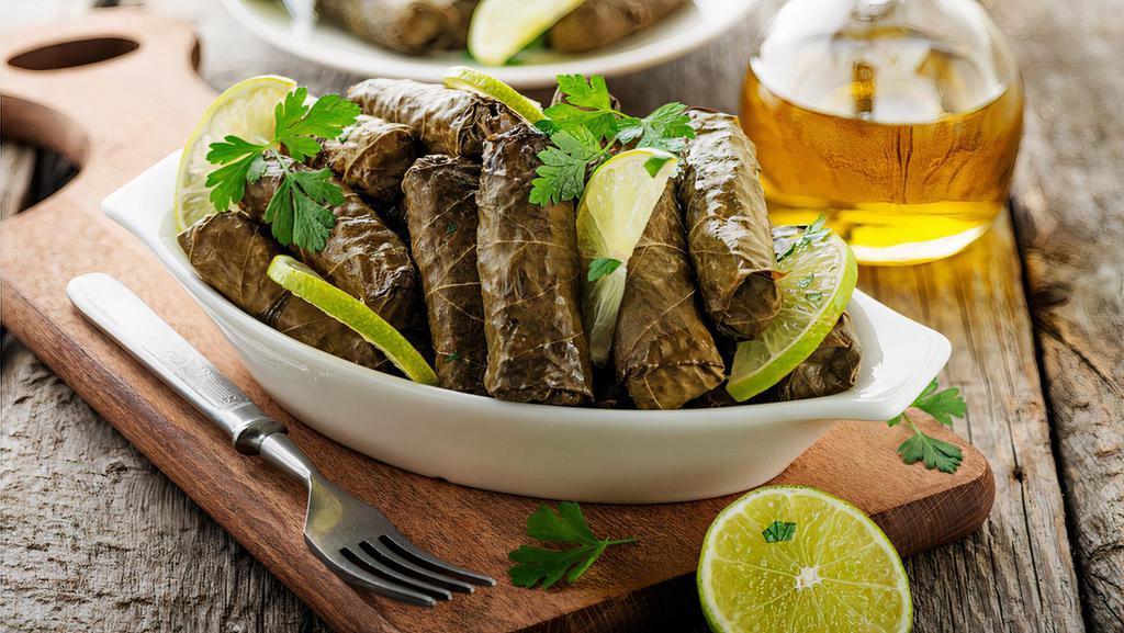 Grape Leaves · Hand-rolled grape leaves stuffed with rice, tomatoes, onions, and parsley