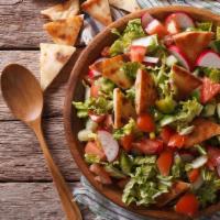 Fattoush · Romaine hearts, tomatoes, cucumbers, carrots, radishes, sliced onion, pita chips, spices and...