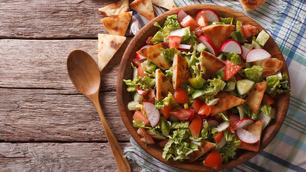 Fattoush · Romaine hearts, tomatoes, cucumbers, carrots, radishes, sliced onion, pita chips, spices and house dressing.