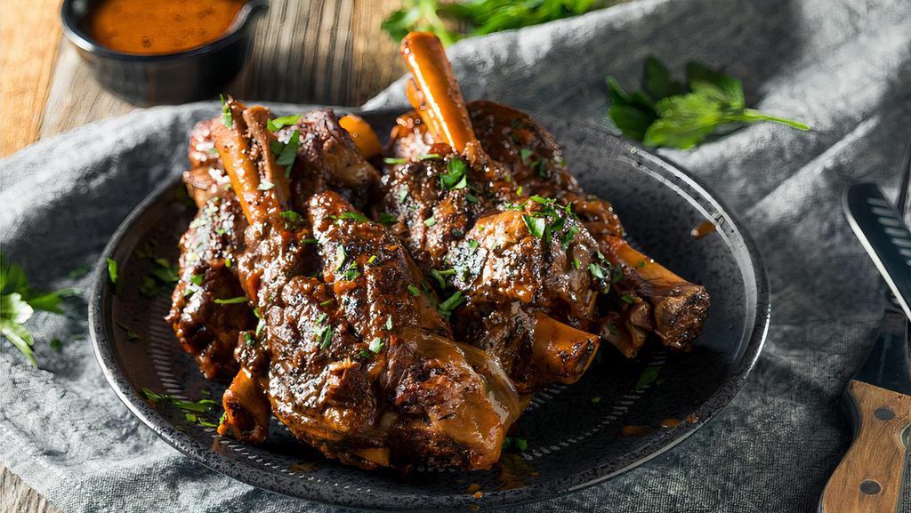 Shank · Slow roasted lamb shanks in a mild sauce of tomatoes, vegetables, and our secret spice mix.