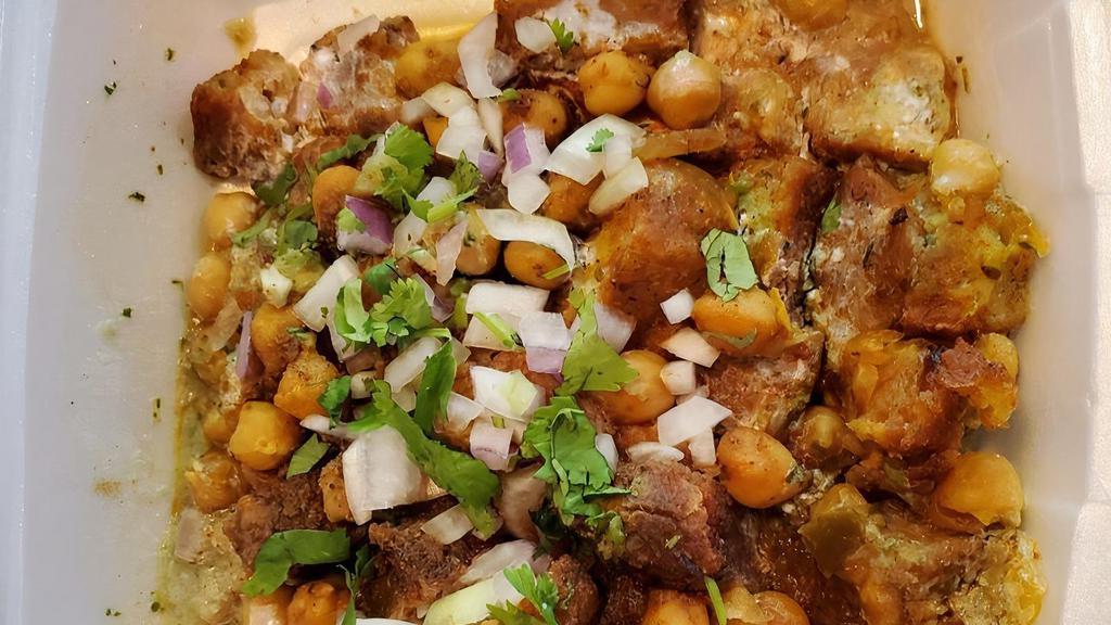 Aloo Tikki Chaat · Chopped aloo Tikki smothered with garbanzo beans and topped with yogurt, mint and tamarind chutney, onions, cilantro, and fresh ground spices.