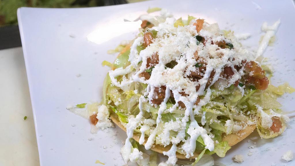Tostada · Crispy tortilla with beans, lettuce, queso fresco, sour cream, salsa fresca and your choice of meat.