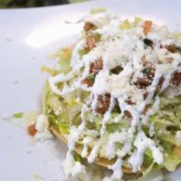 Tostada Salad · Double decker tostada salad with beans, lettuce, salsa fresca, guacamole, sour cream, queso ...