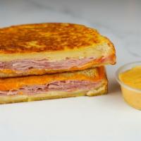 Smoked Ham & Cheese Monte Cristo · Smoked ham, Cheddar, Swiss, and Parmesan cheeses melted between egg dipped, griddled sourdou...