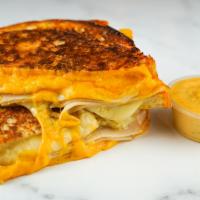 Roasted Turkey & Cheese Monte Cristo · Roasted turkey breast, Cheddar, Swiss, and Parmesan cheeses melted between egg dipped, gridd...