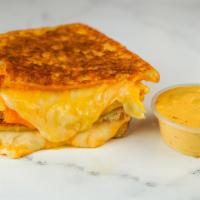 Three Cheese Monte Cristo · Cheddar, Swiss, and Parmesan cheeses melted between egg dipped, griddled sourdough bread. Se...