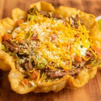 Tostada Bowl · Shredded beef or chicken mixed with beans, lettuce, cheese, guacamole, sour cream and salsa ...