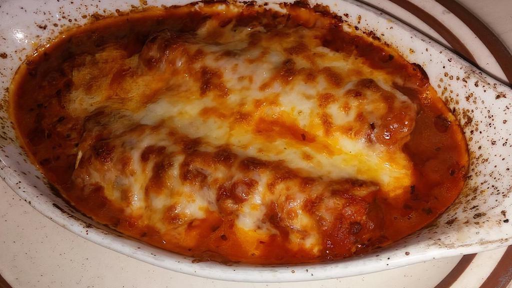 Manicotti Al Forno · Homemade noodles wrapped around a filling of three cheeses, topped with tomato sauce and two cheeses.
