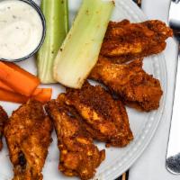 Classic Wings · Tossed in choice of buffalo, bbq, extra spicy, garlic Parmesan, or Cajun dry rub. Served wit...
