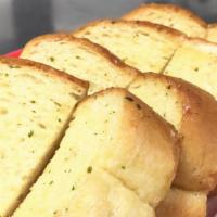 Garlic Bread · Four slices of garlic and butter French breads. Golden brown baked and crispy.